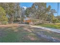 Brick ranch home with a driveway, basketball hoop and large backyard at 1839 Manigault Pl, Charleston, SC 29407