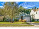 Charming gray house with a two-car garage and lush landscaping at 476 Rockville Rd, Moncks Corner, SC 29461