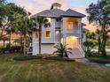 Two-story waterfront home with gray siding and a metal roof at 1109 Pinefield Dr, Wando, SC 29492