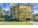 Yellow condo building with parking and landscaping at 4252 Faber Place Dr # 203, North Charleston, SC 29405