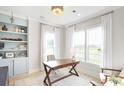 Home office with built-in shelves and large windows offering natural light at 268 Clearpath Dr, Summerville, SC 29486