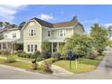 Two-story house with light green siding, a metal roof and manicured lawn at 211 Ilderton St, Summerville, SC 29483