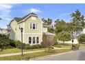 Two-story craftsman style home with a light green exterior and landscaping at 211 Ilderton St, Summerville, SC 29483