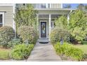 Inviting front porch with a gray door and lush landscaping at 211 Ilderton St, Summerville, SC 29483
