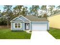 Charming one-story home with gray siding, white door and garage at 2215 Macallan Blvd, Ravenel, SC 29470