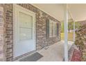 Front porch of brick house with white door and black shutters at 313 Fairlawn Dr, Moncks Corner, SC 29461