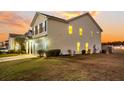 Two-story house with a beige exterior, a white garage door, and a side yard with landscaping at 108 Glenspring Dr, Summerville, SC 29486