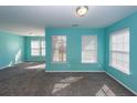 Bright bedroom with light teal walls and grey carpeting at 9044 Parlor Dr, Ladson, SC 29456