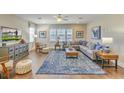 Spacious living room with a sectional sofa, large TV, and blue area rug at 137 Winding Grove Ln, Moncks Corner, SC 29461