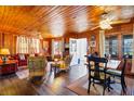 Cozy living room with wood paneling, hardwood floors, and fireplace at 3131 Palmetto Blvd, Edisto Island, SC 29438