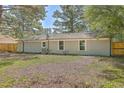 Large backyard with a wooden fence and mature trees at 3264 Stonehaven Dr, North Charleston, SC 29420