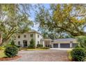 Two-story home exterior with three-car garage and mature trees at 371 Live Palmetto Bluff, Mount Pleasant, SC 29464