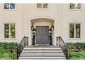 Elegant front entry with double doors, iron railings, and potted plants at 371 Live Palmetto Bluff, Mount Pleasant, SC 29464