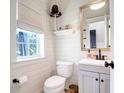 Small bathroom with white shiplap walls and a gray vanity at 1421 Oldenburg Dr, Mount Pleasant, SC 29429