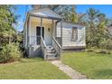 Gray bungalow with a covered porch and steps leading to the entrance at 2671 Olympia Ave, North Charleston, SC 29405