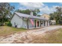 View of the home's side, showing the metal roof and landscaping at 3034 Cane Slash Rd, Johns Island, SC 29455