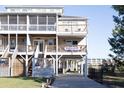 Three-story beach house with multiple decks and a paved driveway at 3611 Yacht Club Rd # B, Edisto Island, SC 29438