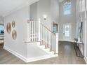 Elegant staircase with white railings and hardwood floors at 4023 Cascades Thrust, Summerville, SC 29483