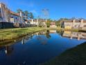 Tranquil pond reflecting townhouses in a community at 403 Reserve Way, Summerville, SC 29485
