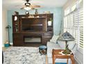 Cozy living room with a large TV, built-in shelving, and fireplace at 404 Claymoor Village Ln, Summerville, SC 29486
