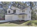 Two-story white house with black shutters, gray roof, and a two-car garage at 5629 Ellington School Rd, Ravenel, SC 29470
