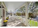 Spacious front porch with white railings, ceiling fan, and view of neighborhood at 780 Post Oak Dr, Mount Pleasant, SC 29464