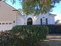 House exterior featuring a white garage door and lush landscaping at 1584 Oakhurst Dr, Mount Pleasant, SC 29466