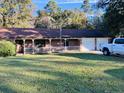 Brick ranch home with carport, yard, and truck at 1848 N Highway 15, Saint George, SC 29477