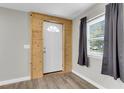 Inviting entryway with wood-paneled accent wall and vinyl flooring at 1979 Macon Ave, North Charleston, SC 29405