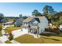 Two-story house with gray siding, white garage door, and landscaped yard at 2009 Elvington Rd, Johns Island, SC 29455