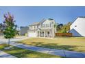 Two-story house with gray siding, white garage door, and landscaped yard at 2009 Elvington Rd, Johns Island, SC 29455