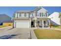 Gray two-story house with white garage door, porch, and American flag at 2009 Elvington Rd, Johns Island, SC 29455