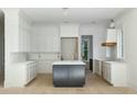 Spacious kitchen with white cabinets, quartz countertops, and a large island at 2715 Old Oak Walk, Seabrook Island, SC 29455