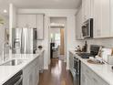 Modern kitchen with stainless steel appliances and white quartz countertops at 314 Calm Water Way, Summerville, SC 29486