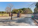 Gated entrance with brick pillars, showcasing a grand entrance to the property at 4415 Lord Proprietors Rd, Hollywood, SC 29449