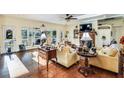 Bright living room with hardwood floors, comfy seating, and large windows at 4415 Lord Proprietors Rd, Hollywood, SC 29449