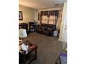 Living room with brown leather reclining sofa and carpet at 4450 Hardwood St, Ladson, SC 29456