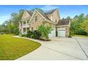 Brick home with a two-car garage and large driveway at 1068 Blockade Runner Pkwy, Summerville, SC 29485