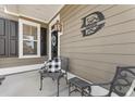 Front porch with black and white decor at 1850 Grovehurst Dr, Charleston, SC 29414