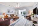 Cozy living room features a brown sofa, armchairs, and a large TV at 1984 Folly Rd # B108, Charleston, SC 29412