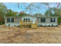 New manufactured home with a front deck and landscaping at 220 Dean Dr, Summerville, SC 29483