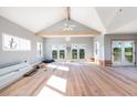 Spacious living area with hardwood floors and access to a deck at 422 Pelican Flight Dr, Dewees Island, SC 29451