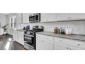 Modern kitchen featuring white cabinets and granite countertops at 570 Richfield Way, Summerville, SC 29486