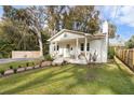 White brick house with a front porch, walkway, and fenced yard at 717 W Luke Ave, Summerville, SC 29483