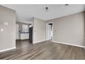 Spacious living room with wood-look floors and neutral walls at 1243 Pineville Cir, Pineville, SC 29468