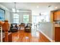 Hardwood floors, two leather armchairs, and a view into the kitchen and dining area at 3532 Claremont St, Mount Pleasant, SC 29466