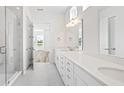 Bright bathroom with double vanity, quartz countertop, and glass shower at 435 Evening Glow Ln, Summerville, SC 29486