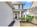 Inviting front porch with seating area and decorative wreath at 223 Laurel Crest Way, Summerville, SC 29486