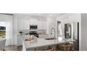 Modern kitchen featuring white cabinets, stainless steel appliances, and a large island at 572 Richfield Way Way, Summerville, SC 29486