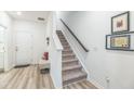 Modern carpeted staircase with a simple dark wood handrail at 823 Recess Point Dr, Moncks Corner, SC 29461